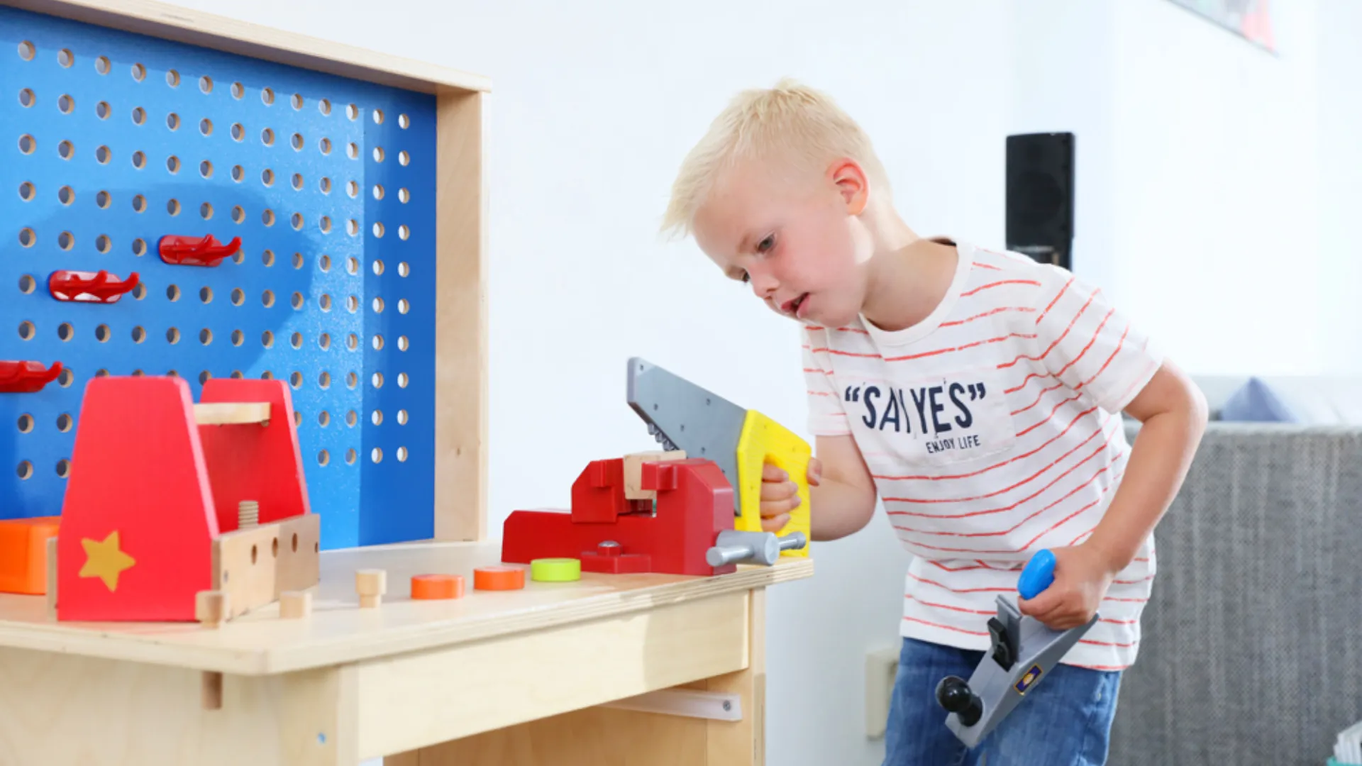 Kind speelt met speelgoed gereedschap